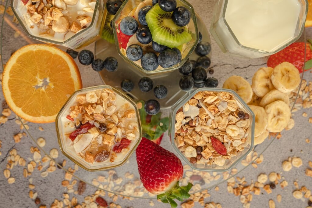 a table topped with bowls of fruit and yogurt