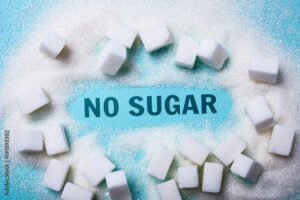 NO SUGAR words on a green background with a bunch of sugar