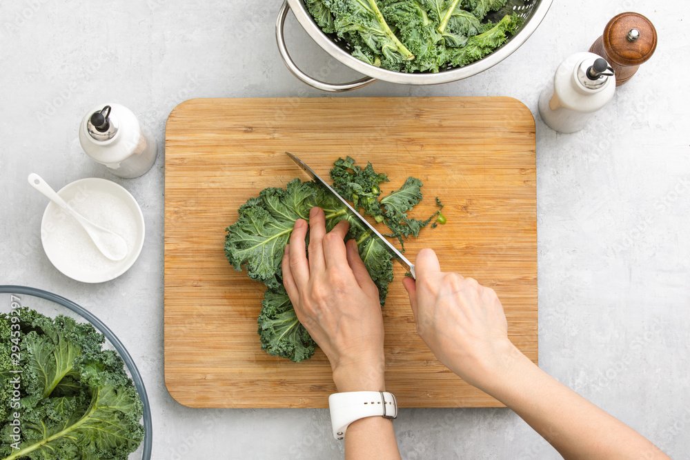 Top down view of fresh kale leaves cut on a cutting board